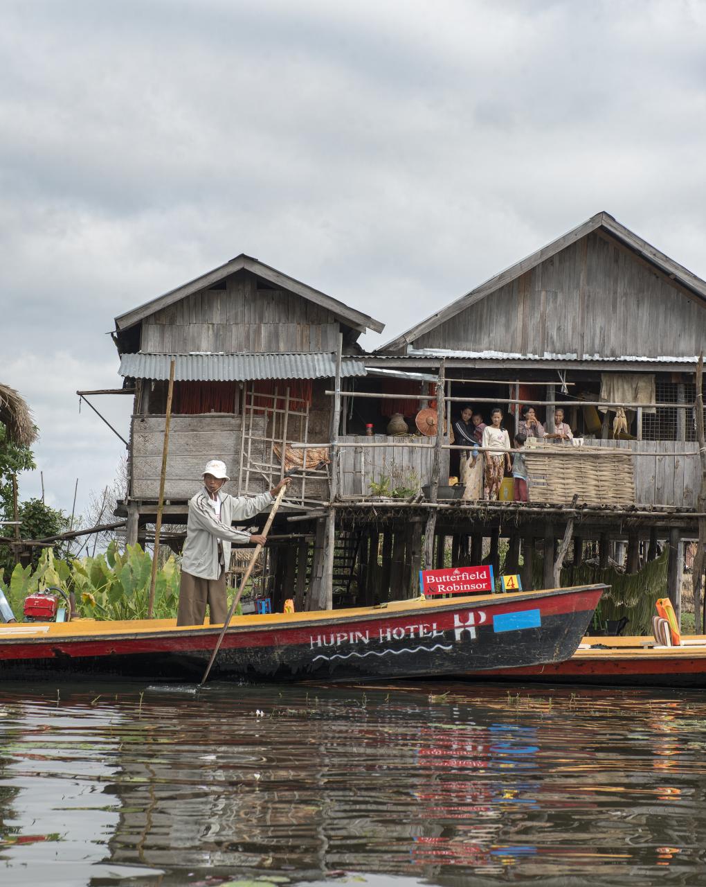 the two people are on a boat in the water