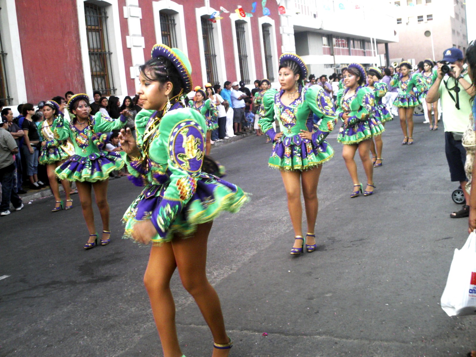 dancers with colorful attire performing on a city street