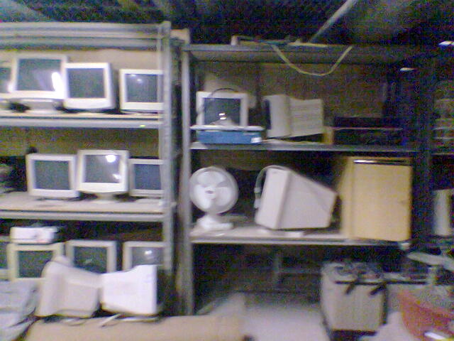 rows of electronics stacked on shelves in the room