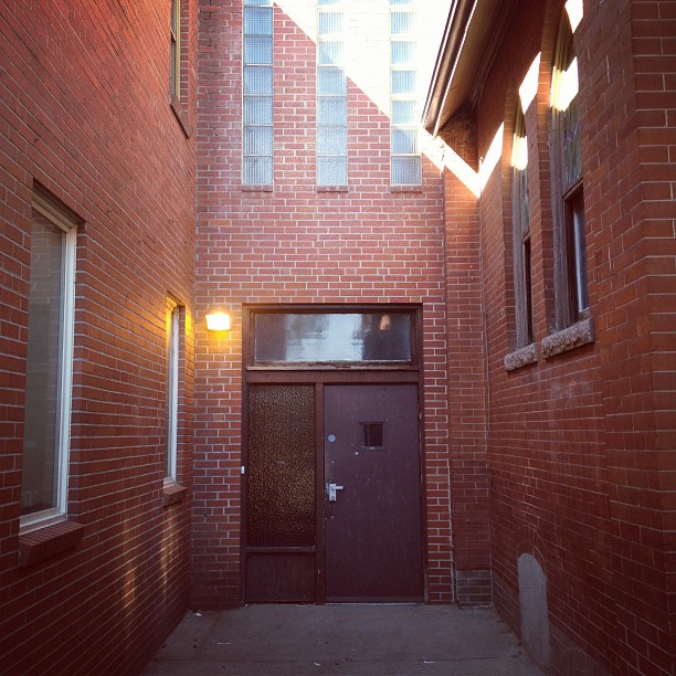 a building with a door in it and a bright light shining over