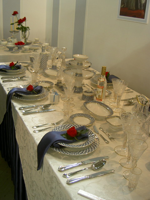 a table with plates and place settings and flowers on it