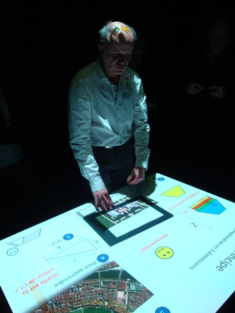a man in glasses and a white shirt is using an ipad