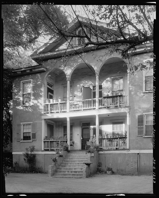 the front of a large house with several balconies