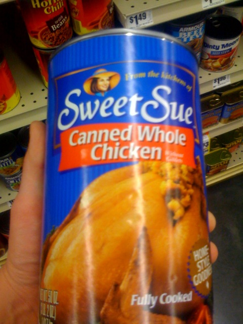 a can of sweet sue canned whole chicken on the shelf in a store