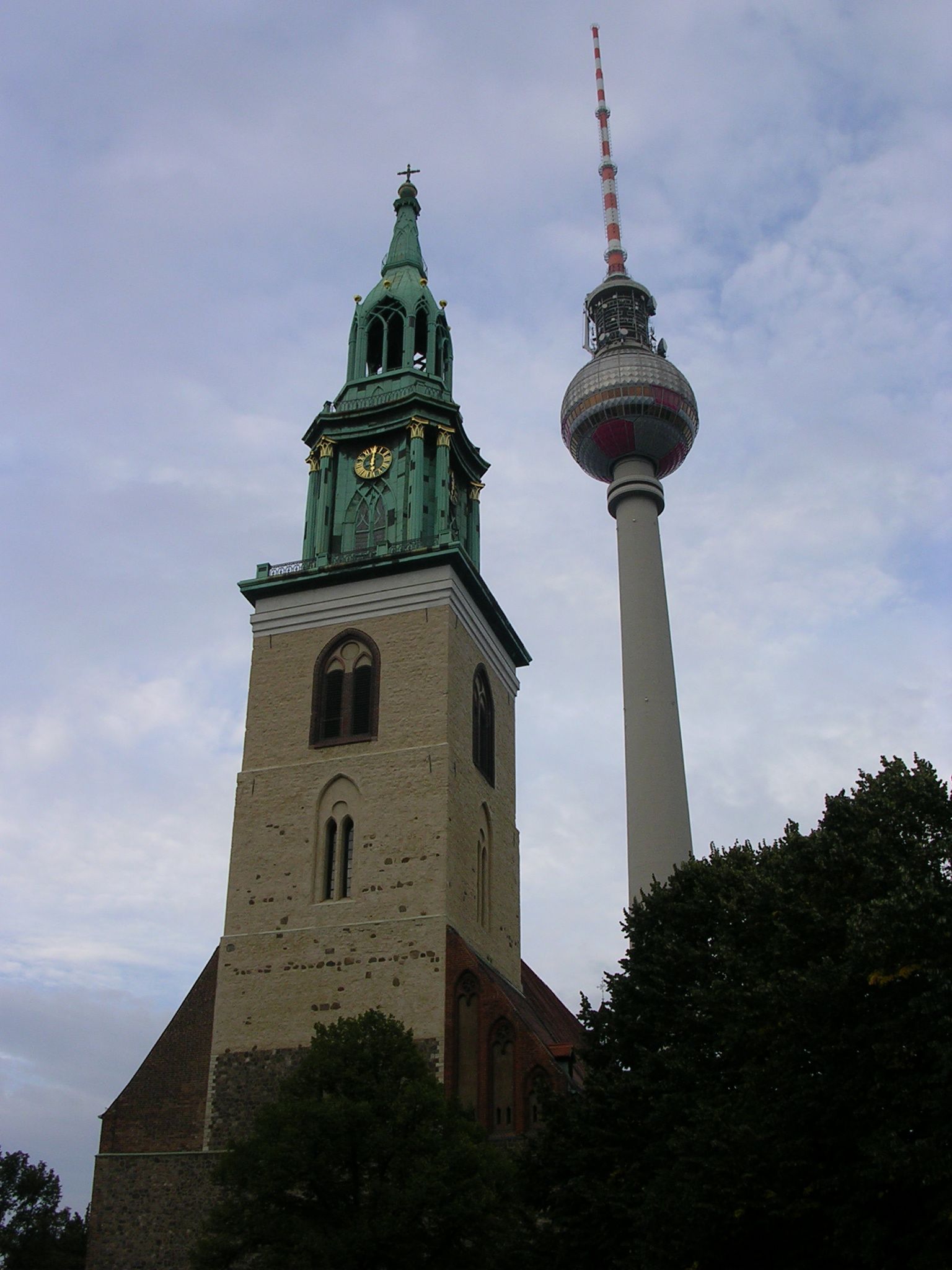 a tower with a clock on it near a tree