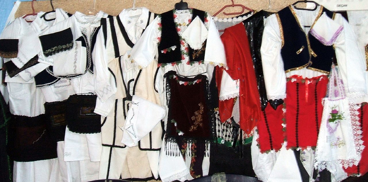 many different types of clothes hanging on a rack