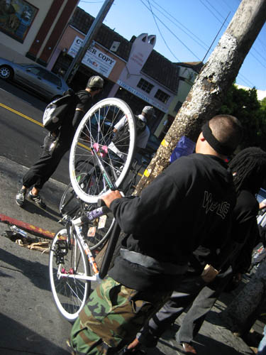 the people look at the white bike in the mirror