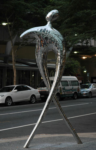 there is a very shiny statue that is on the street