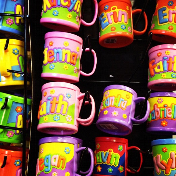 colorful coffee cups and mugs hanging on a wall