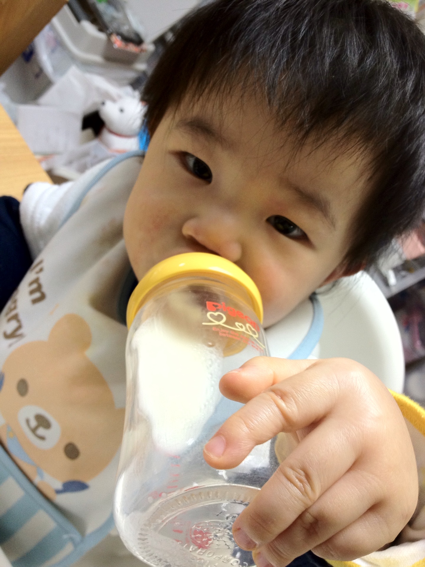 a young child drinking out of a sippy cup
