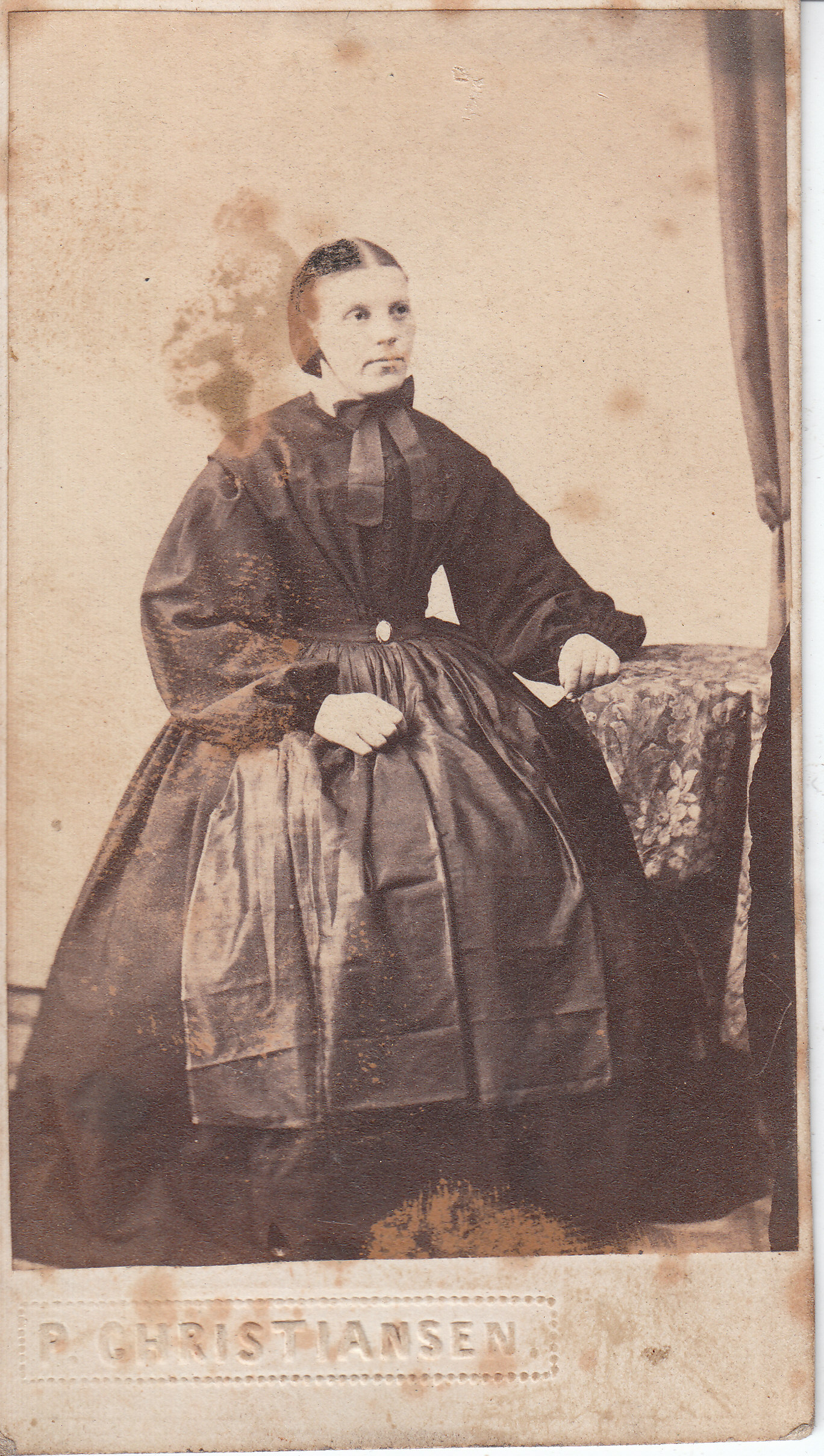 a black - and - white po of a young woman wearing a dress