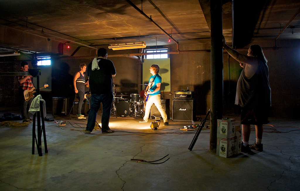 a group of people playing music in a dark room
