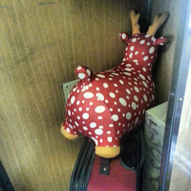 a stuffed animal sitting on top of a piece of luggage