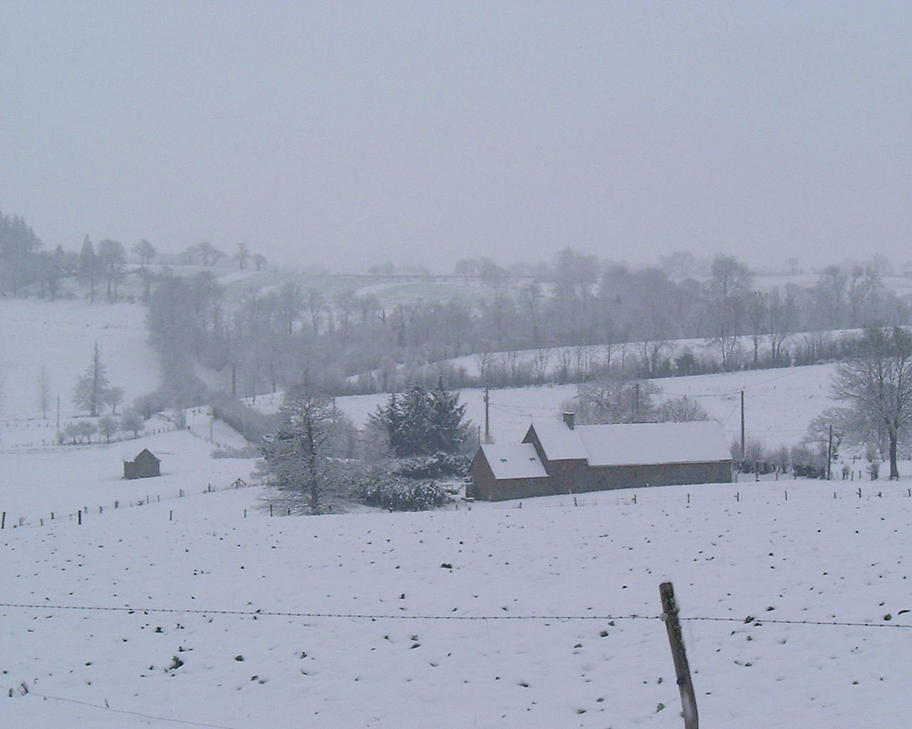 an idyllic winter scene of a snowy farm