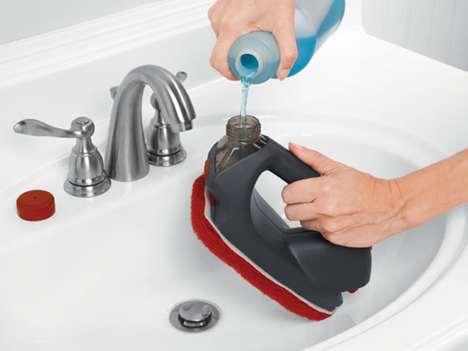 a woman cleaning her bathroom sink with a spray