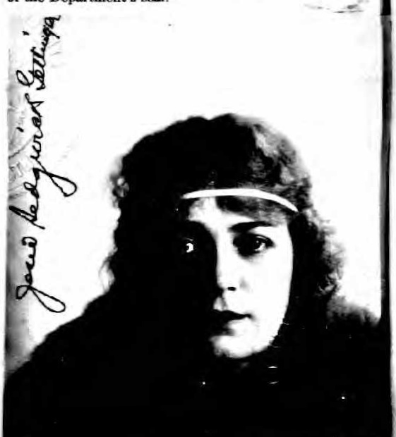 black and white pograph of a woman with long hair wearing a headband