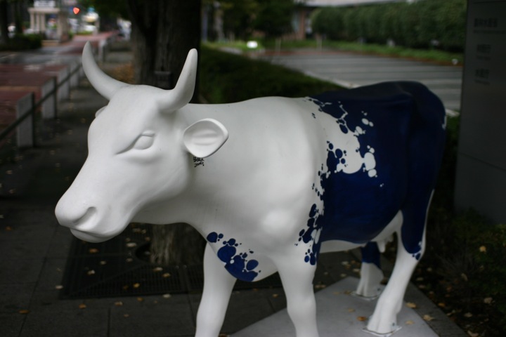 a sculpture of a cow with blue and white spots