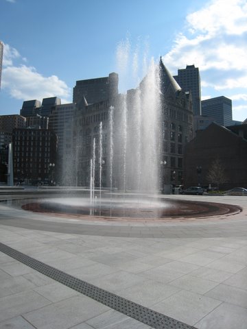 a small fountain in the center of a plaza