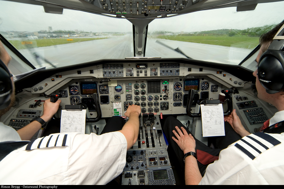 two pilots in the cockpit of a plane