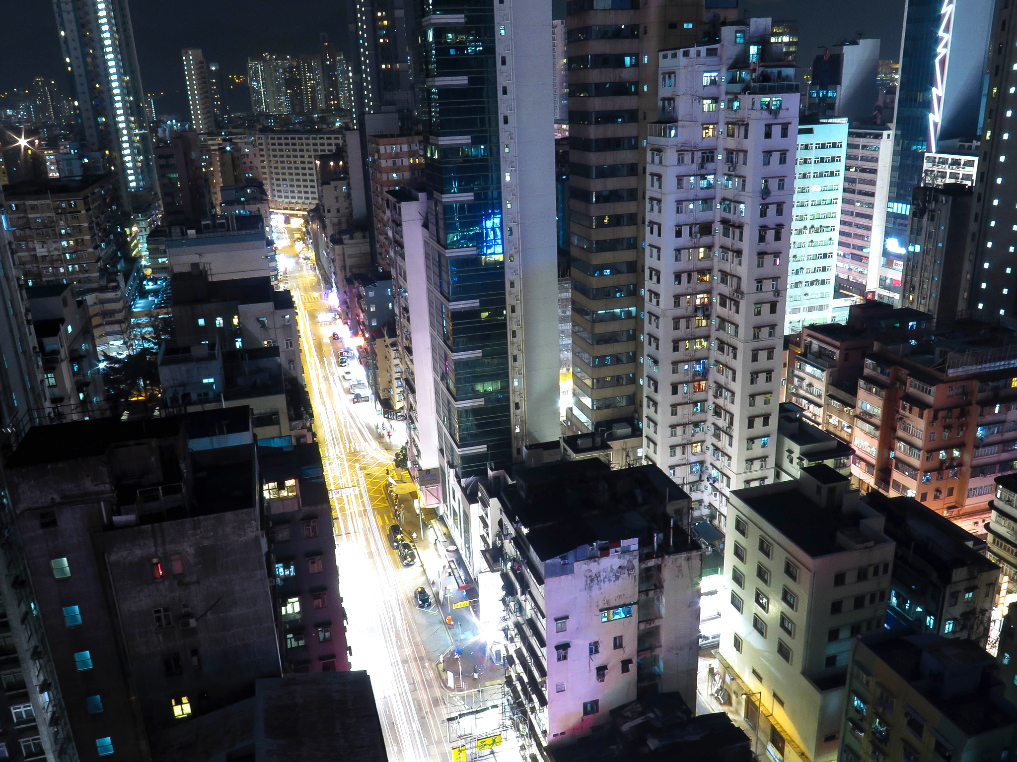 a night time view of buildings in the city with lights on