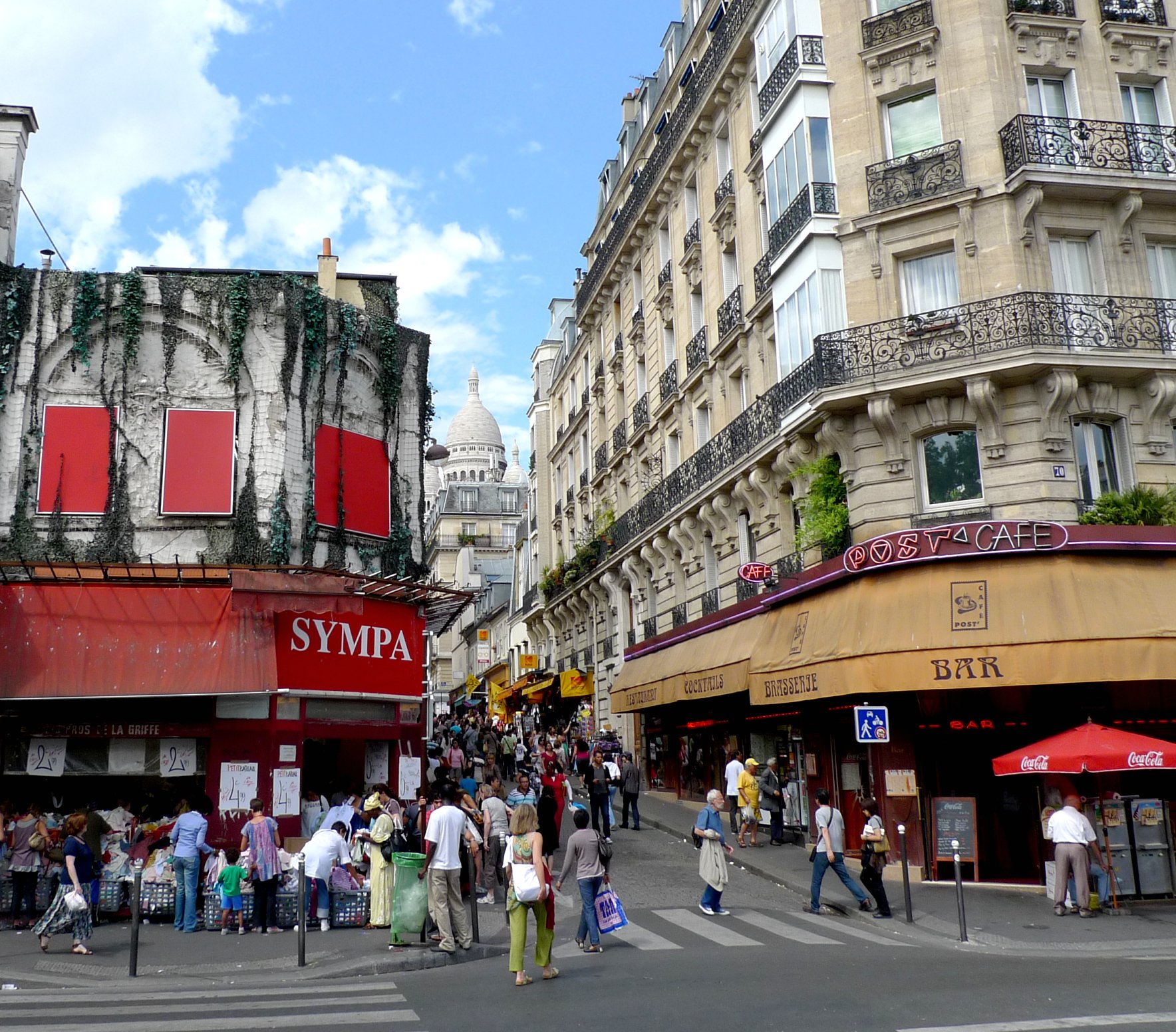 people walking in the street in a very crowded city