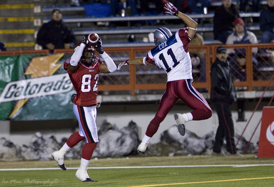 a pair of people on a field playing football