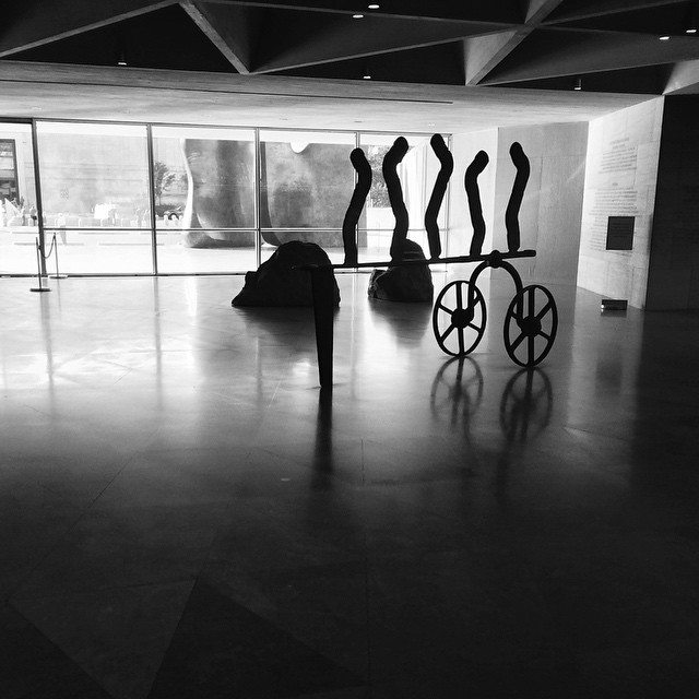a room with multiple sculptures in front of a window