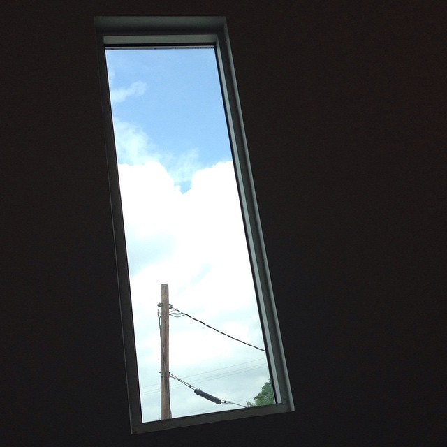 a window view of wires against the sky