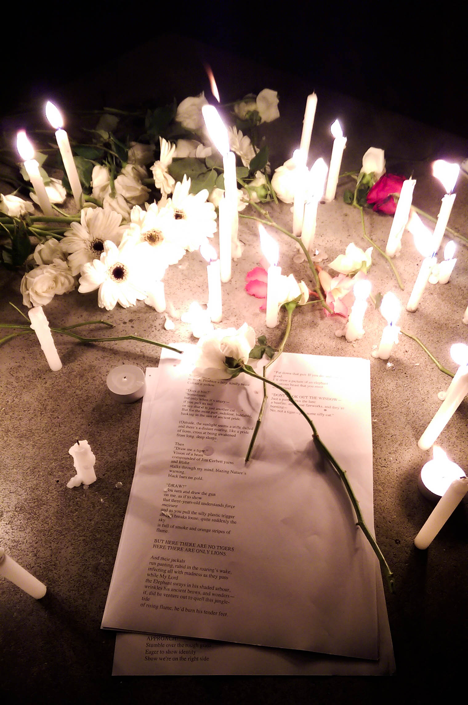 flowers, candles, and letters are laid out on a table