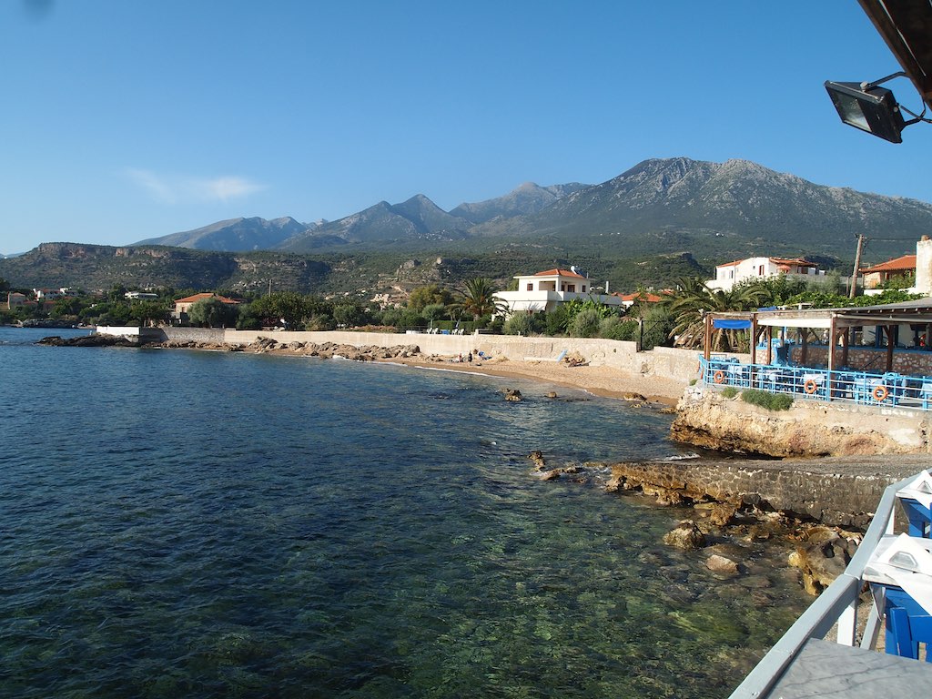 the view from an empty pier shows a coastline