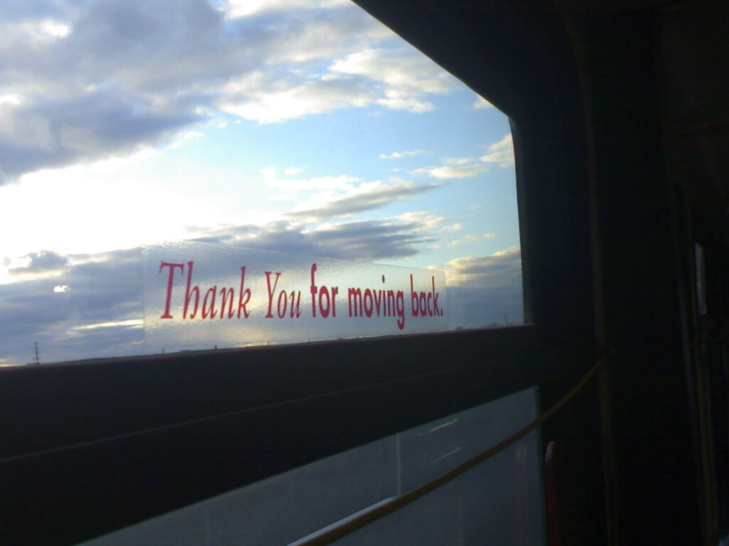 a sign posted on the side of a window in an airport