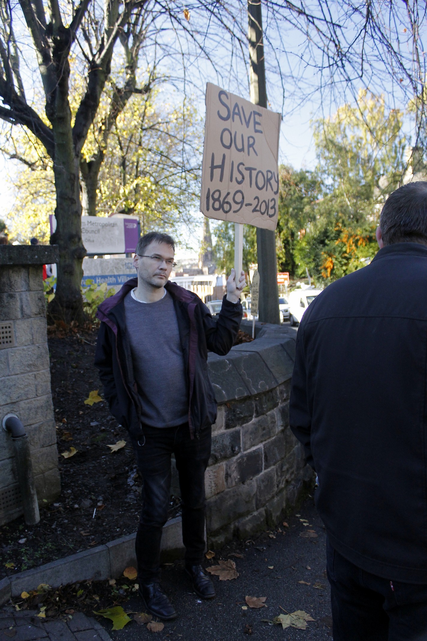 man holding up a sign with the same words on it