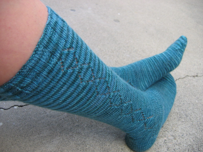a person with blue socks with holes on them