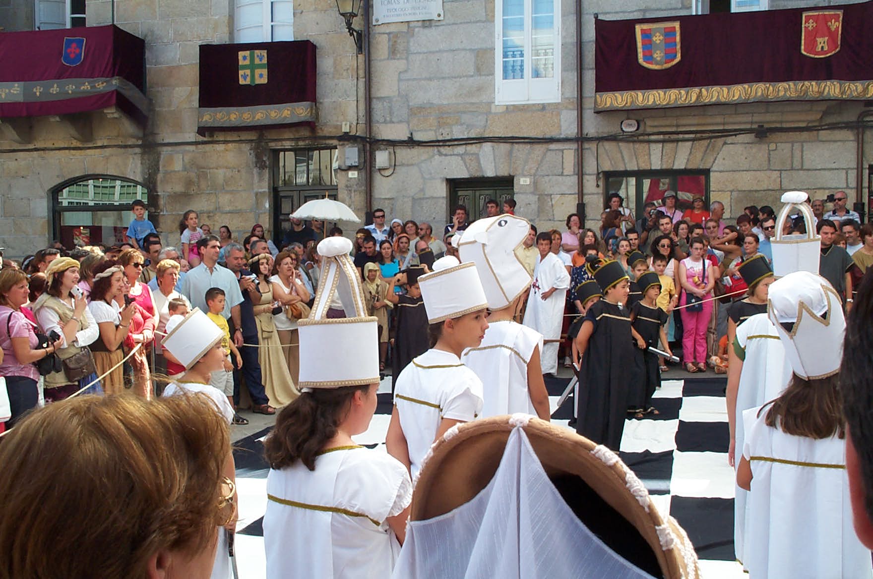 a group of people dressed in costumes on a chess board
