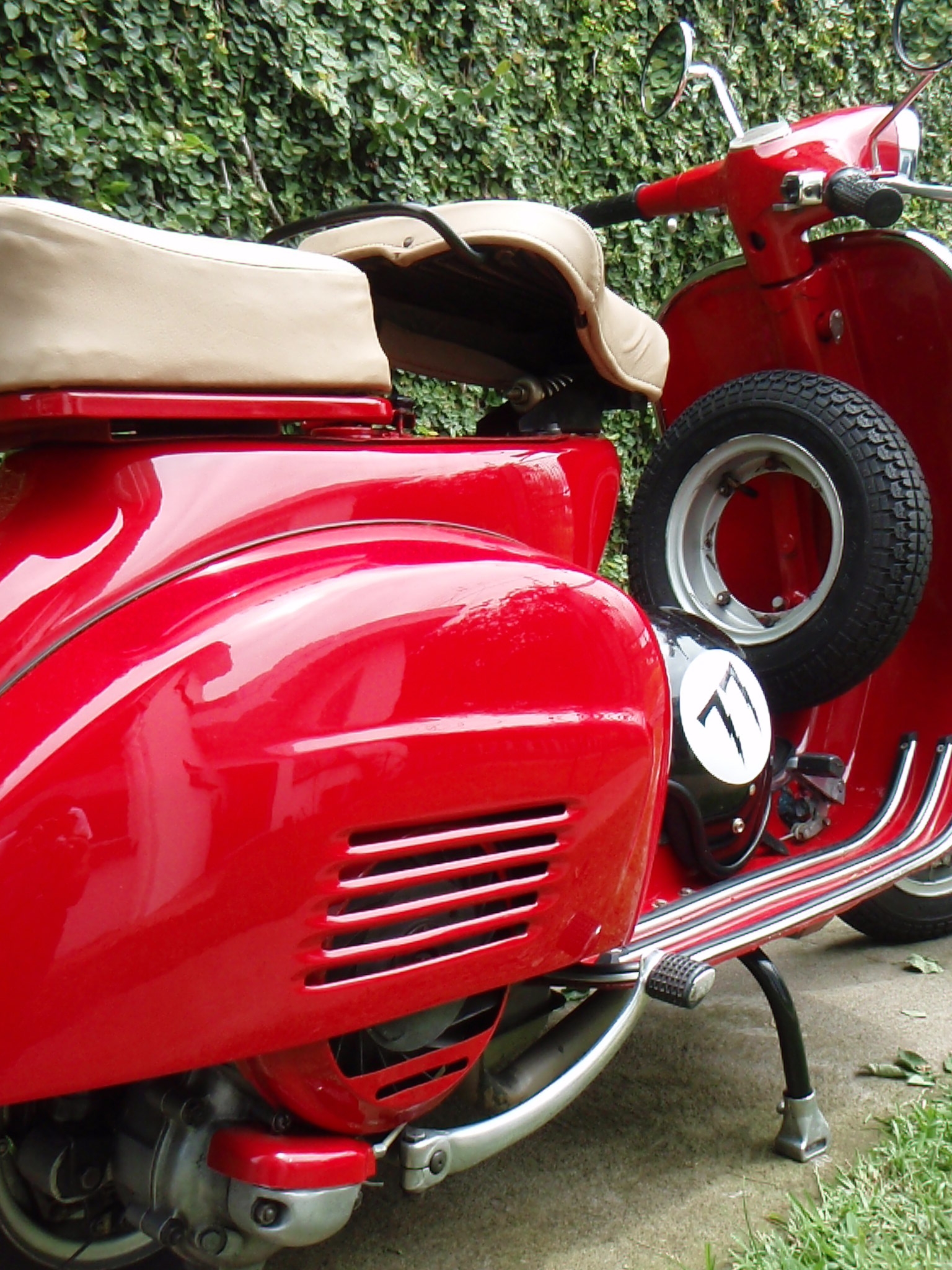 the motor scooter has leather seat covers on it