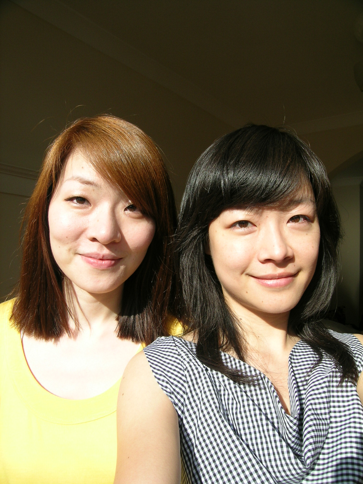 two asian ladies who are both smiling for the camera
