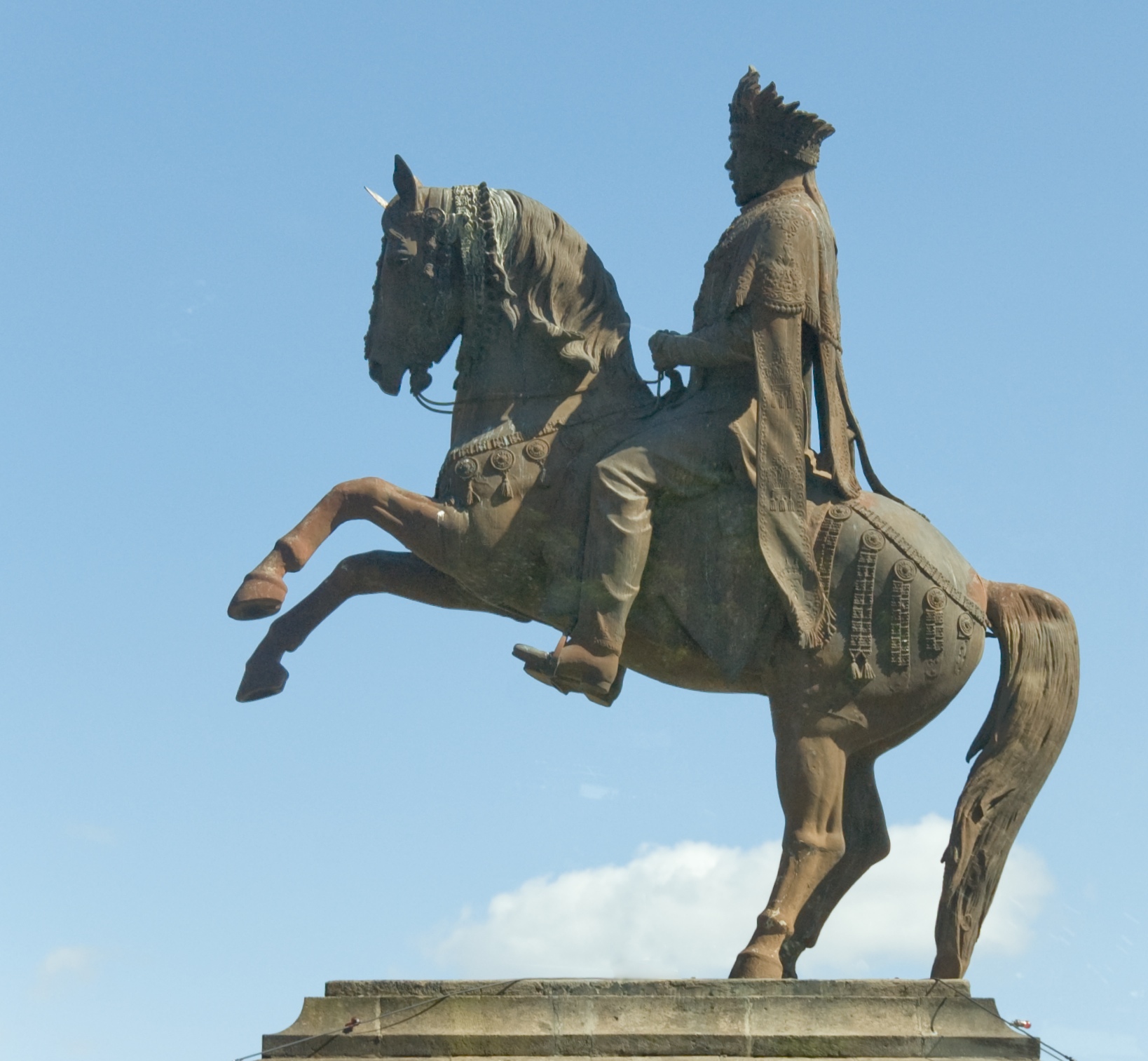 the statue has a man riding on it's horse