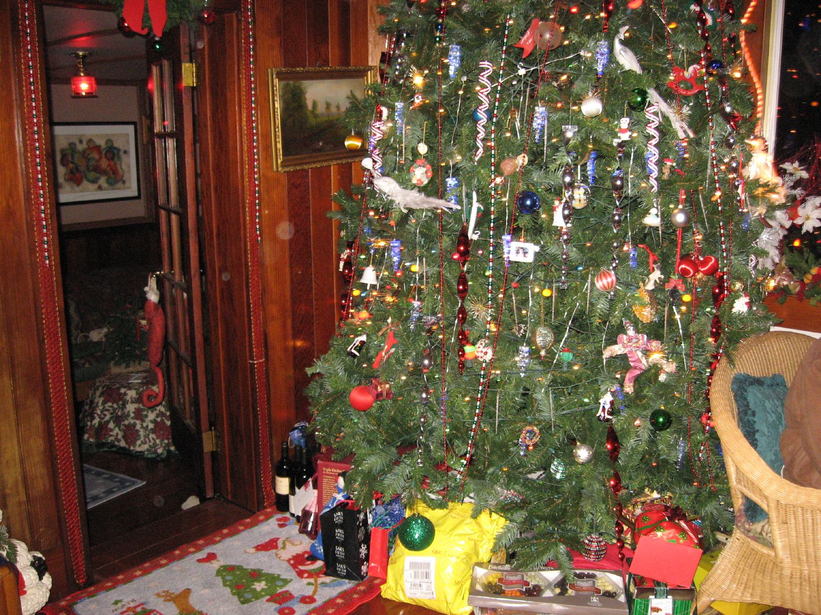 the decorated christmas tree has a lot of presents on it