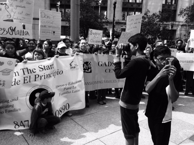 group of people at a rally in front of a building