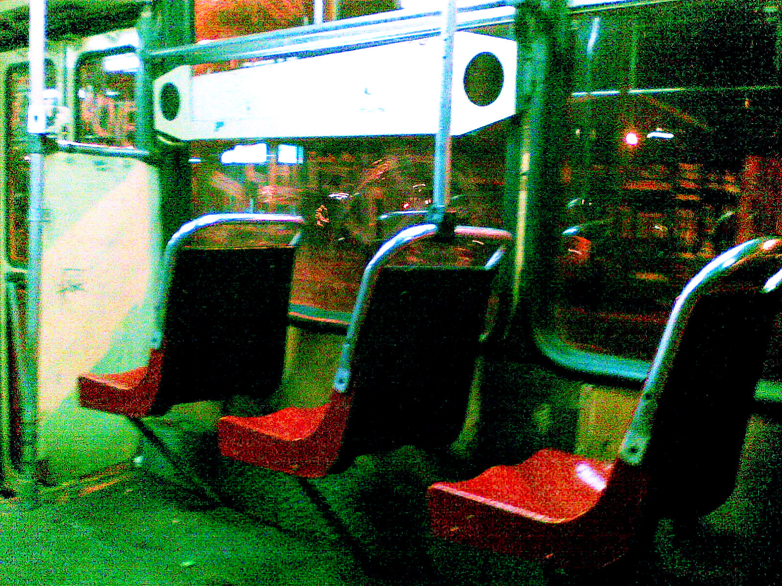 an empty public transportation bus with red seats