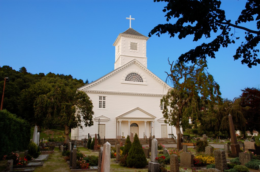 a church in an old cemetery with a cross on top