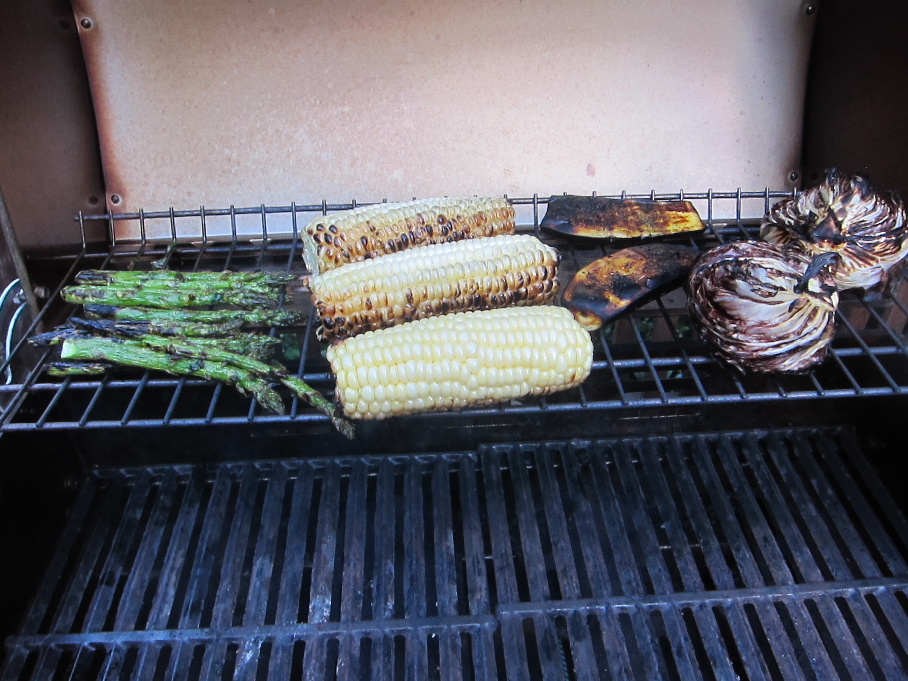 grilled vegetables being placed on top of the grill