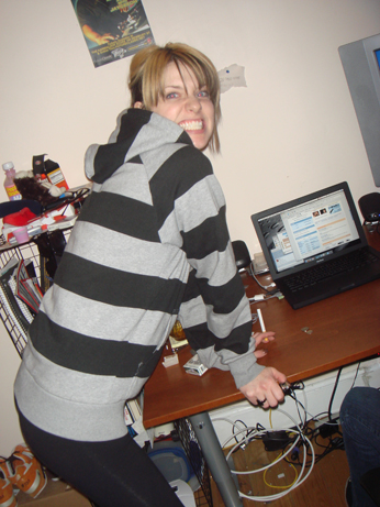 a woman poses while using her lap top computer
