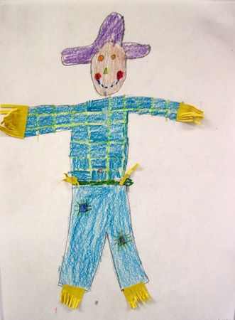 a paper scarecrow in blue and yellow