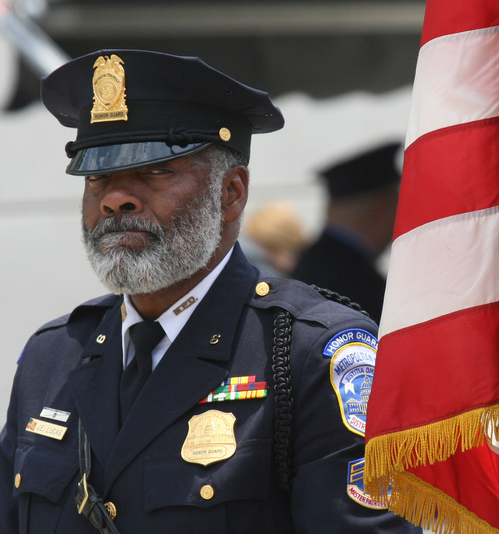 a military man is in uniform near an american flag