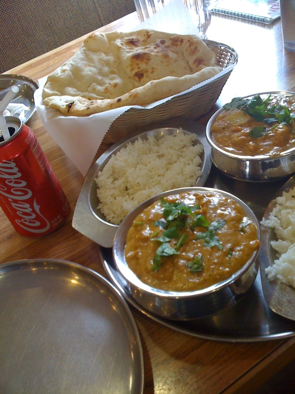 a group of food on a tray, including rice and some chips