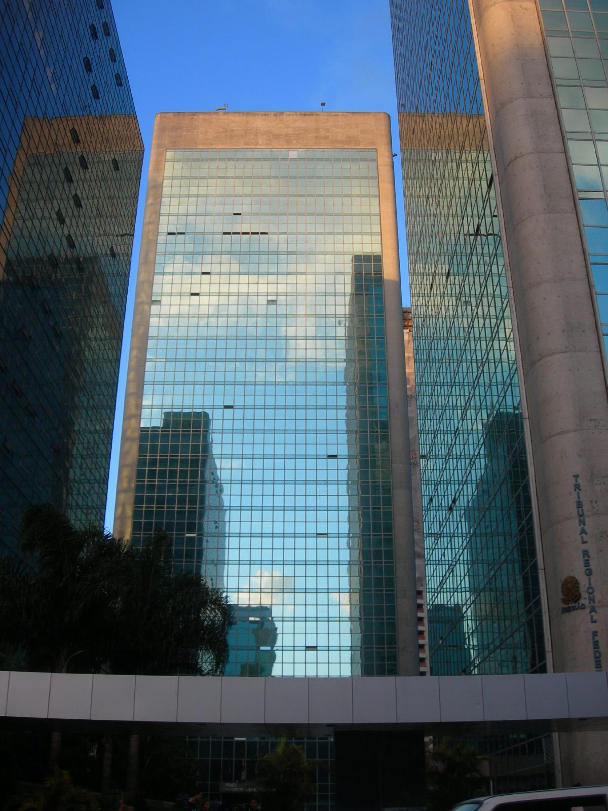 there are several very high rise buildings that can be seen reflected in the glass windows