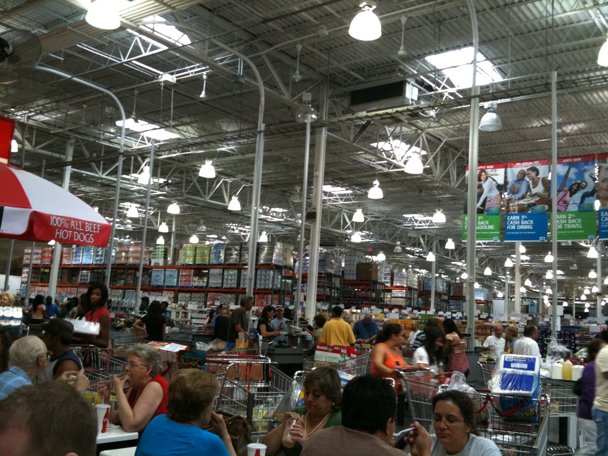 a grocery store filled with people sitting down and shopping