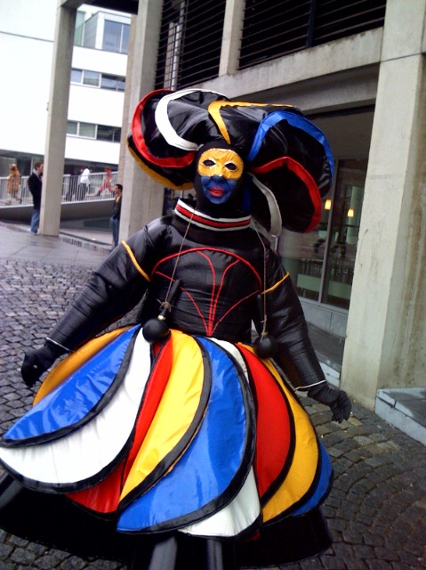 a woman in a colorful outfit on a bicycle