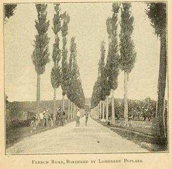 an old po of people walking on the side of a road